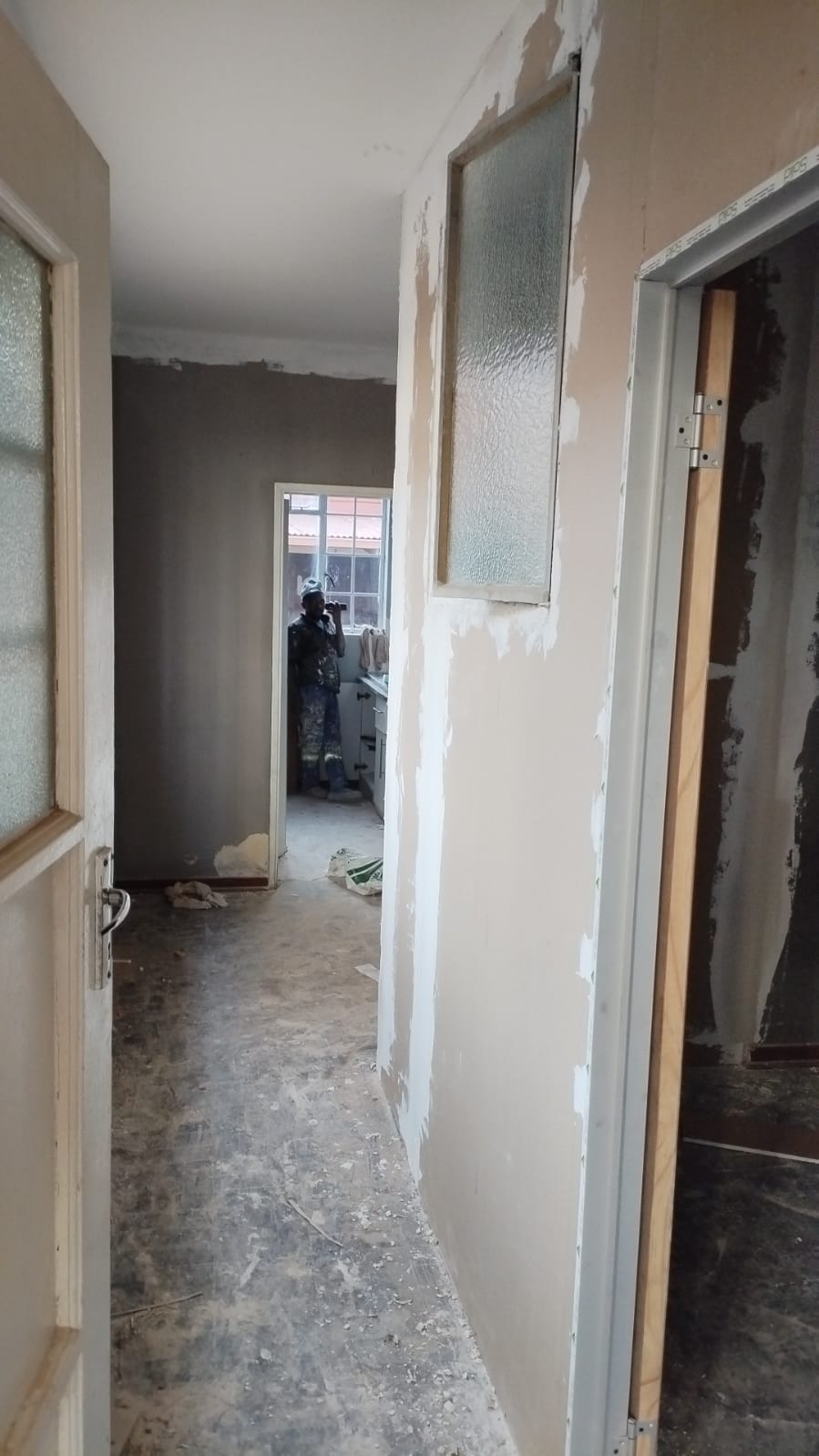 Wall skimming and door frame installation in progress