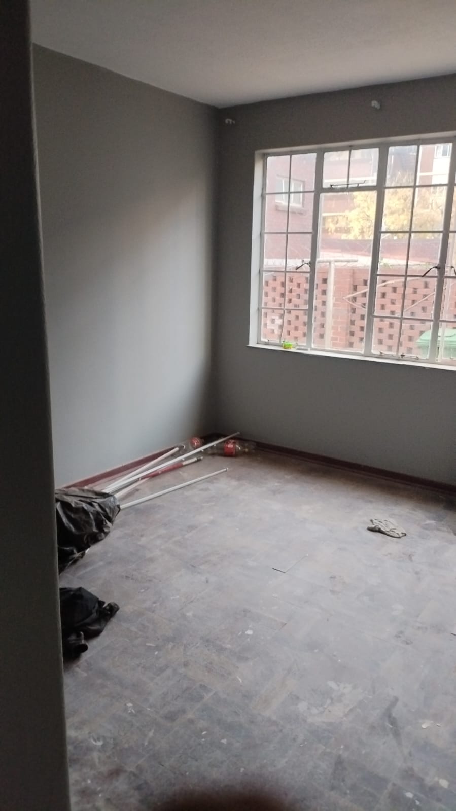 Bare room with damaged flooring before renovation
