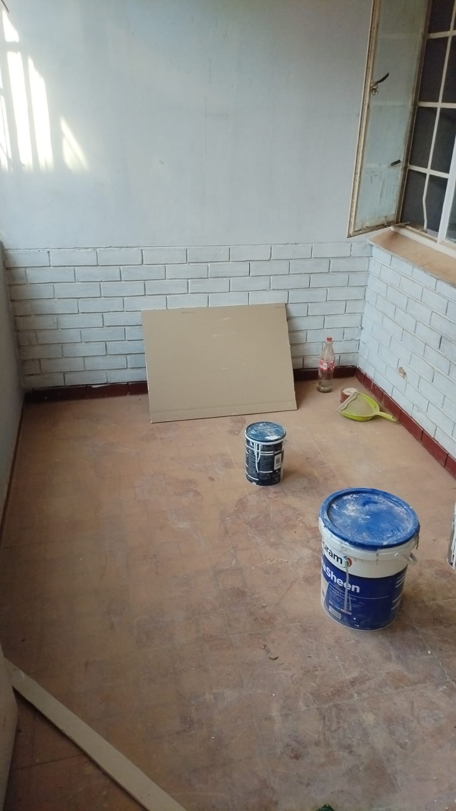 Paint and materials on site, wall prep underway